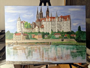 Auf einer Staffelei steht ein farbiges Gemälde. Es zeigt die Burg in Meißen, deren Umrisse sich in der Elbe Spiegeln.